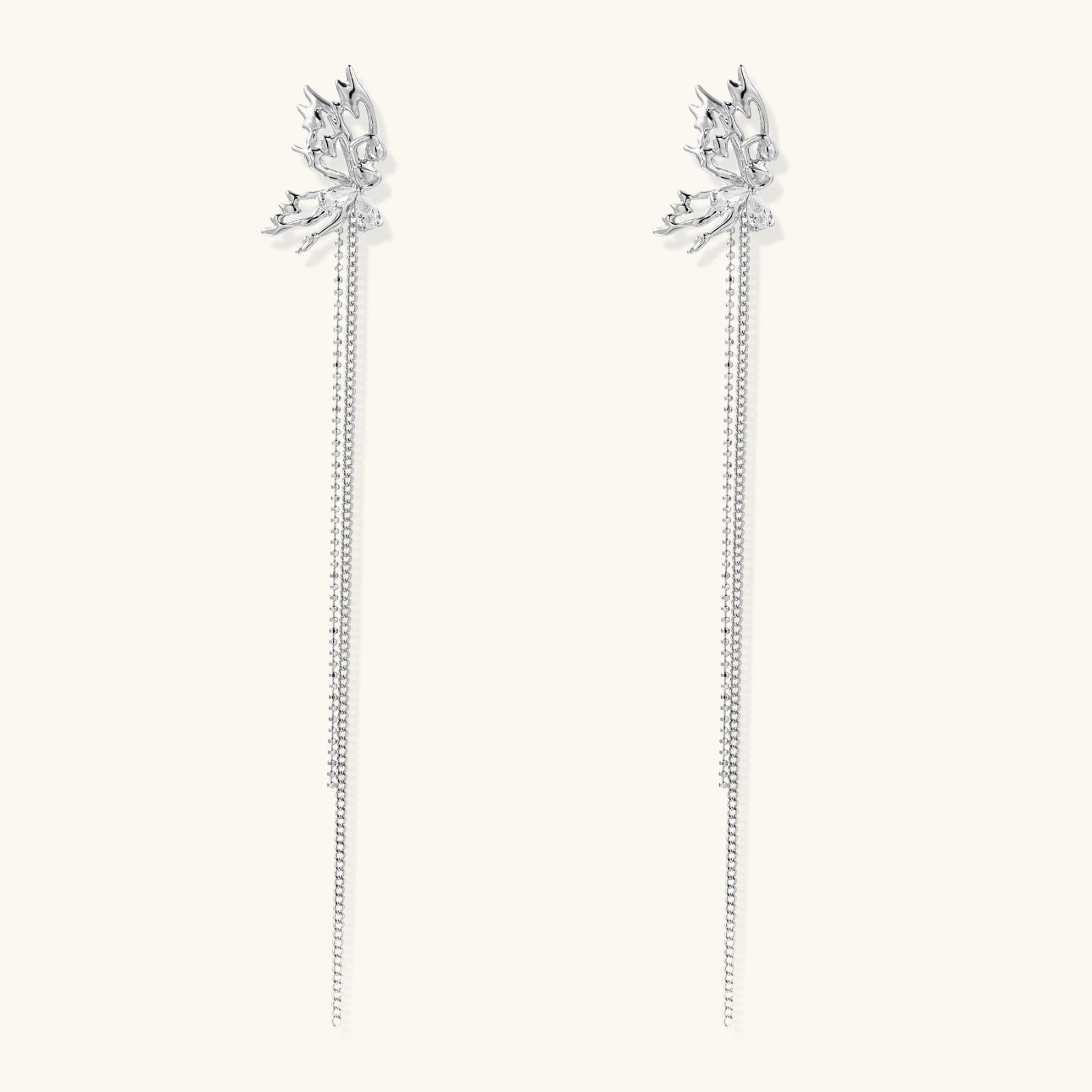 Silver-toned threader earrings featuring detailed fairy figure with wings and dual delicate chain strands, zirconia accents