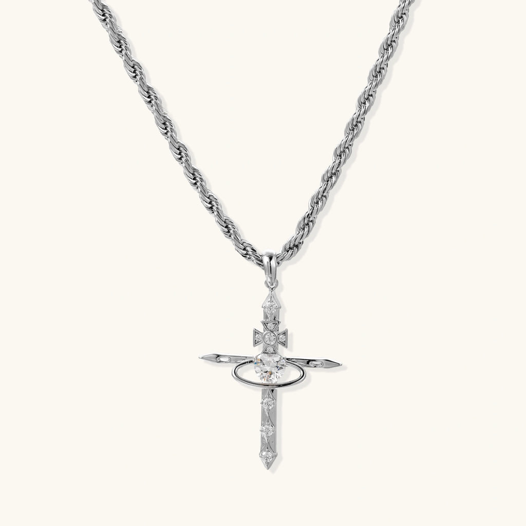 Silver-tone necklace with dimensional orb pendant, cross crown detail, and zirconia stones on twisted rope chain
