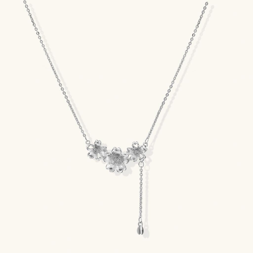 White gold plated Y-shaped necklace with three dimensional flower charms and adjustable drop pendant